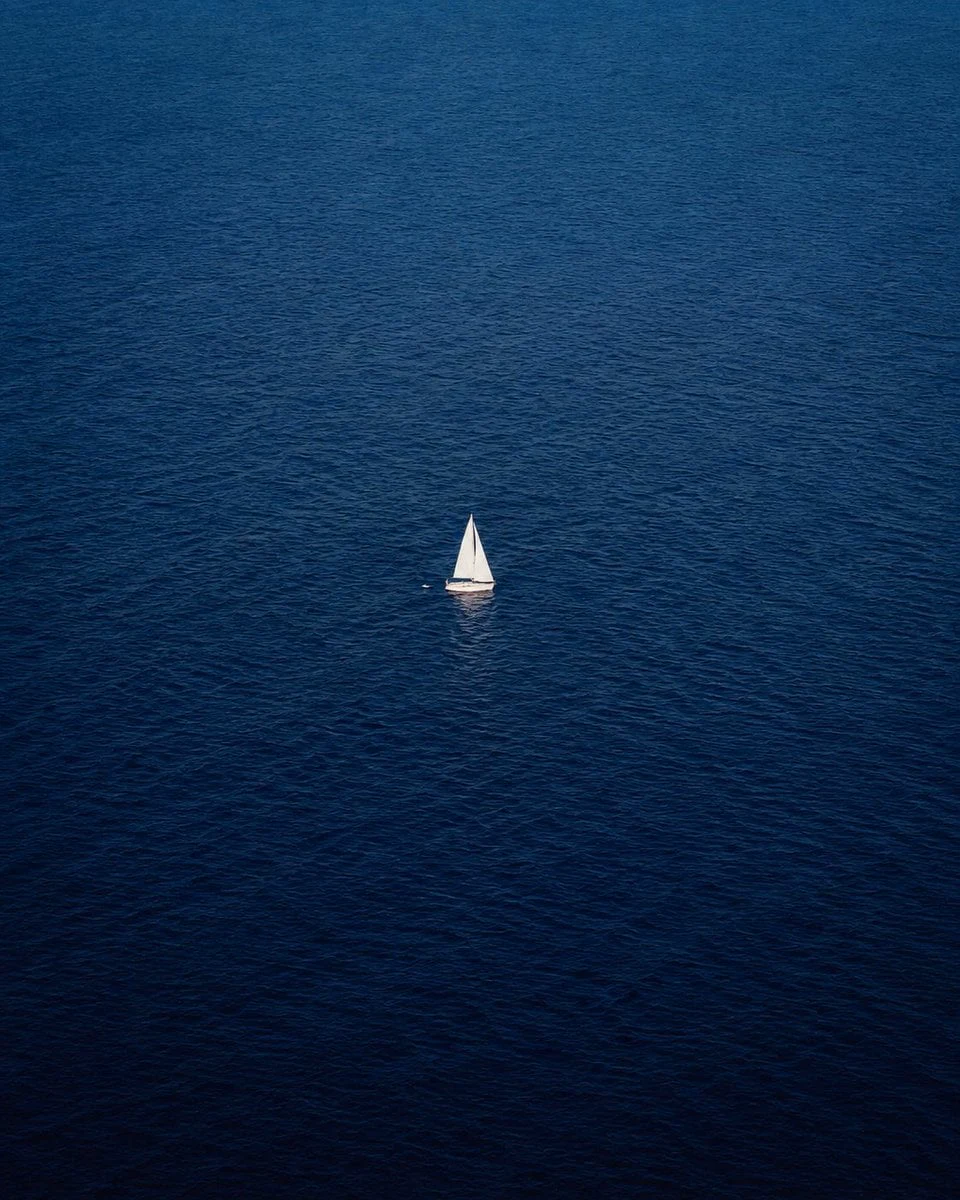 Prompt 1: An ultra-minimalist aerial drone photograph of a vast deep-blue ocean stretching endlessly in every direction. A single small white sailboat is perfectly isolated near the center of the frame, emphasizing solitude, freedom, and scale. The sea has subtle ripples and rich navy-to-cobalt blue tones with natural texture. The composition features extensive negative space, creating a calm, cinematic, and peaceful atmosphere. Shot from a very high altitude with a top-down telephoto perspective, the sailboat appears tiny against the immense ocean. Soft natural daylight, realistic water reflections, crisp details, photorealistic, fine art travel photography, luxury editorial aesthetic, National Geographic style, Hasselblad medium-format camera, 100mm lens, ultra-sharp focus, HDR, 8K resolution, clean composition, minimalist color palette, no land, no horizon, no people visible, only the solitary sailboat surrounded by endless sea.

Prompt 2: An ultra-minimalist aerial drone photograph of an endless dense evergreen forest stretching to the horizon. A single tiny white paraglider with a clean white canopy floats perfectly near the center of the frame, emphasizing solitude, freedom, and the immense scale of nature. The forest consists of tightly packed dark pine and fir trees, creating a rich deep-green texture with subtle variations in tone. Captured from an extremely high altitude with a top-down telephoto perspective, the paraglider appears tiny against the vast forest canopy. The composition features abundant negative space, creating a calm, cinematic, and contemplative mood. Soft overcast natural light, gentle atmospheric haze, realistic tree textures, crisp details, photorealistic, fine-art landscape photography, luxury editorial aesthetic, National Geographic style, Hasselblad X2D medium-format camera, 100mm telephoto lens, ultra-sharp focus, HDR, 8K resolution, muted green color palette, no mountains, no roads, no rivers, no buildings, no other people or aircraft, only the solitary paraglider above the endless forest. Hyper-realistic, cinematic, award-winning aerial photography.